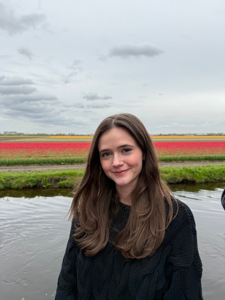 Standing in front of fields of red tulips in Amsterdam. 
